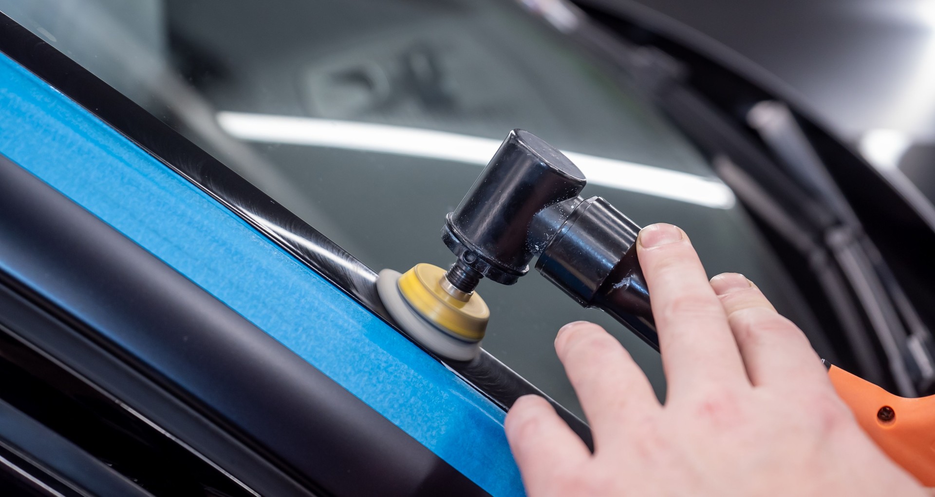 Car detailing series: Polishing gray car close-up. The process of polishing the car body in close-up.